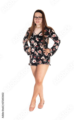 Beautiful teenage girl standing in shorts from the front