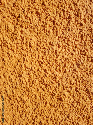 Rough cement, yellow background