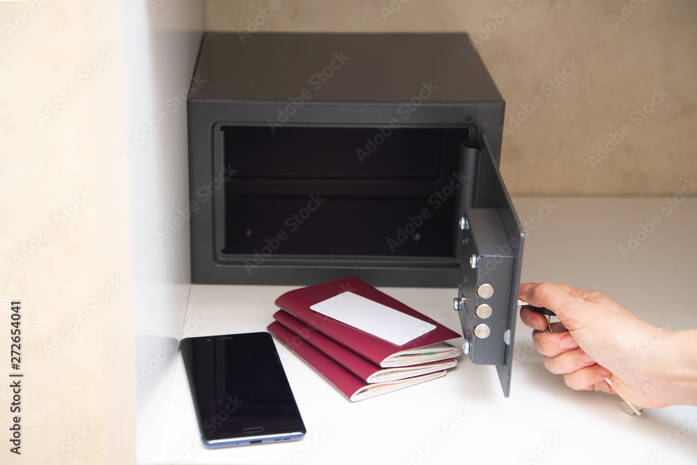 Hand opening safe in the hotel - obrazy, fototapety, plakaty 