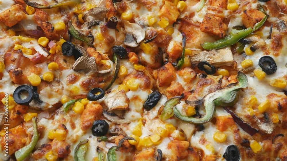 A close up view of a spinning vegetarian pizza. A close up view of a spinning vegetarian pizza.