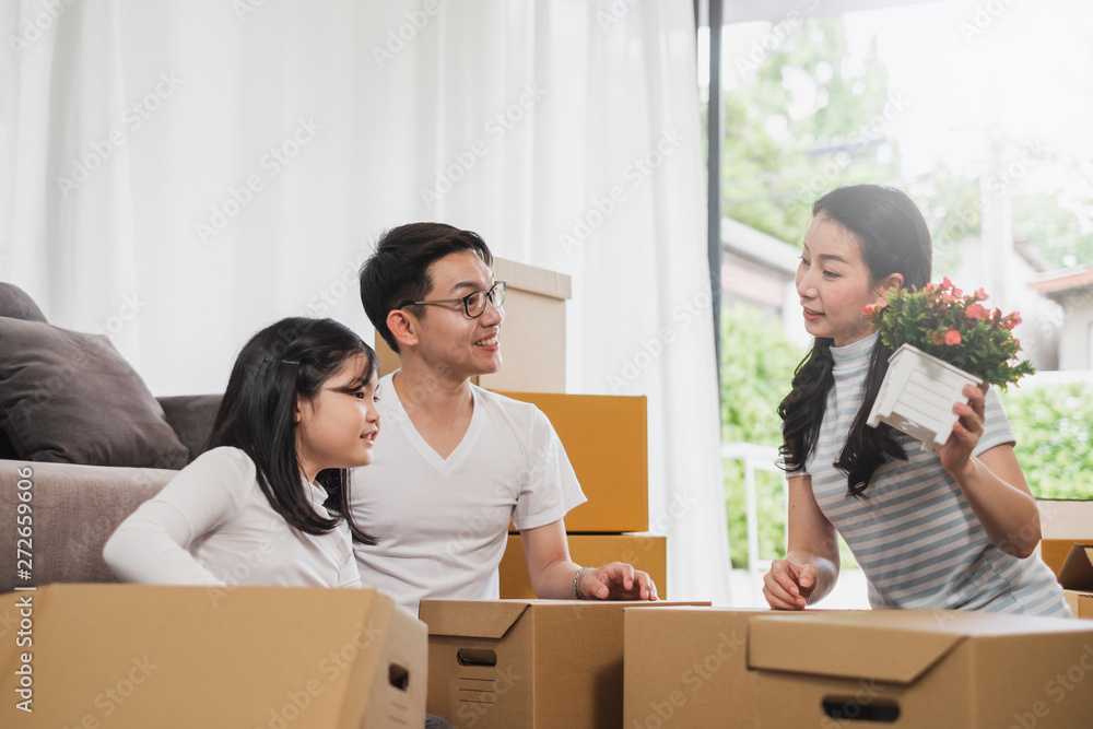 Asian family moving to new home/house and unpacking boxes Asian family moving to new home/house and unpacking boxes