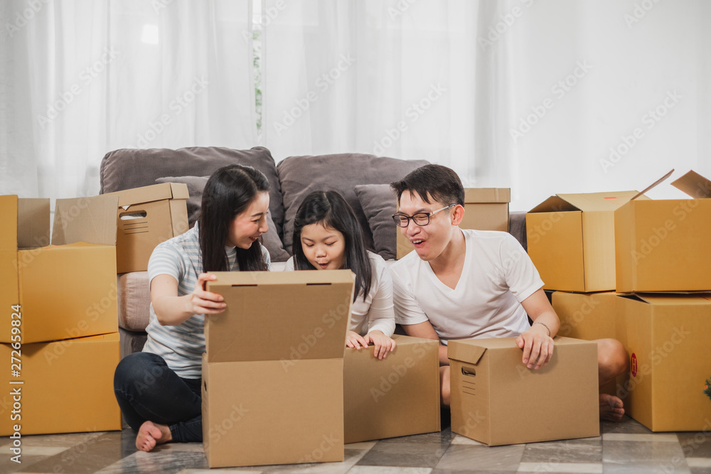 Asian family moving to new home/house and unpacking boxes Asian family moving to new home/house and unpacking boxes