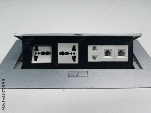 Electrical Universal power outlet popup and LAN plugs on the white meeting table for charging loptop or mobile phone.