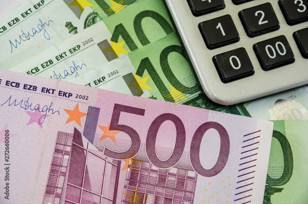 banknotes of 100, 500 euros and a calculator, close-up. banknotes of 100, 500 euros and a calculator, close-up.
