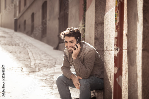 Young attractive happy man talking on smart phone in european city © SB Arts Media