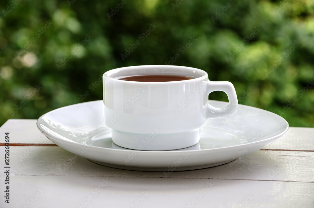 white cup of tea on a white table, close up white cup of tea on a white table, close up