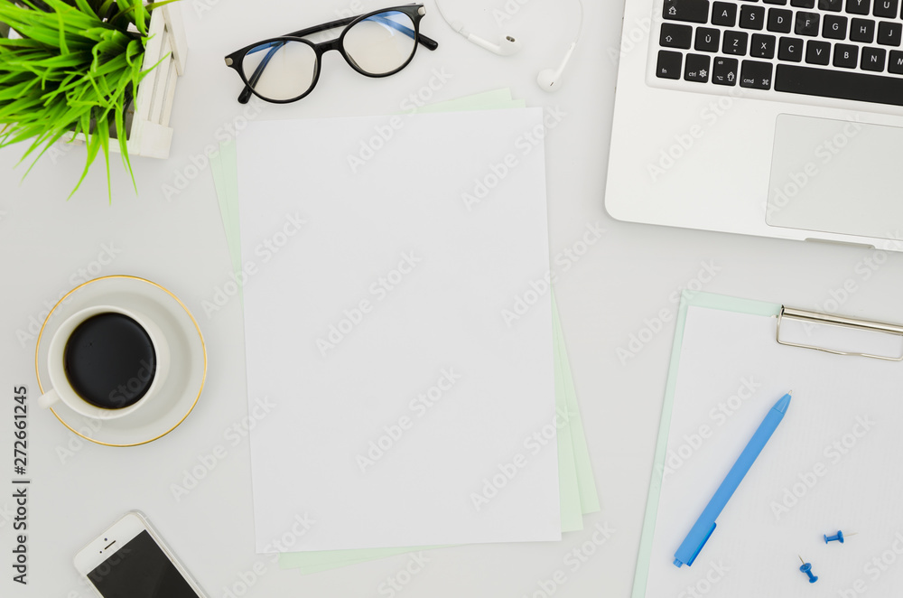 Flat lay paper mockup next to laptop Flat lay paper mockup next to laptop