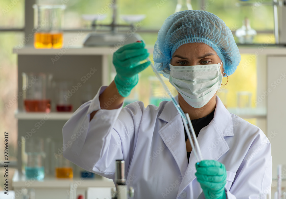 Women in the chemistry laboratory in the science laboratory,nalyzing and experimenting chemical formulas Women in the chemistry laboratory in the science laboratory,nalyzing and experimenting chemical formulas