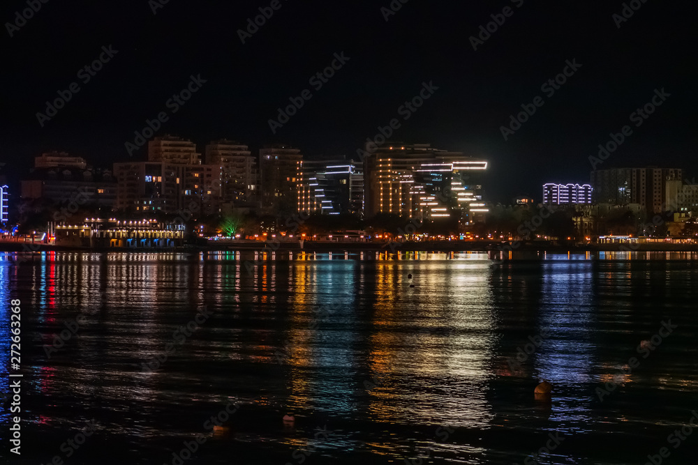 Night Gelendzhik landscape with reflection of city lights in sea water, copy space