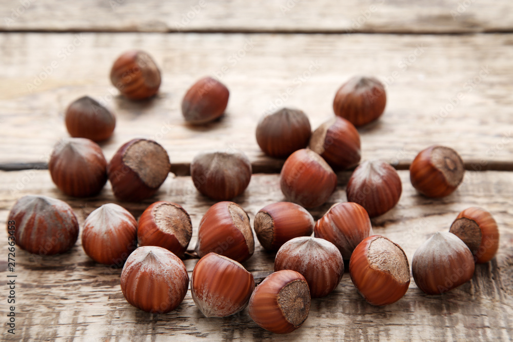 Ripe hazelnuts on brown wooden table Ripe hazelnuts on brown wooden table