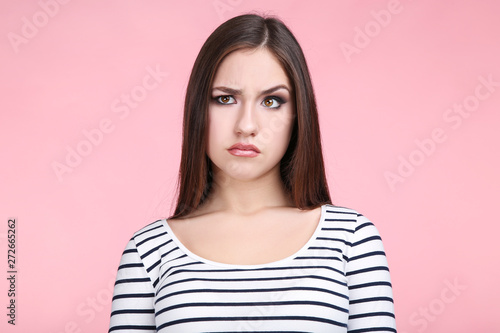 Beautiful young woman on pink background