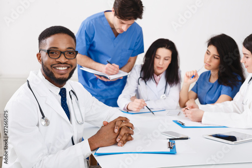 Practitioners And Interns Having Meeting In Medical Office