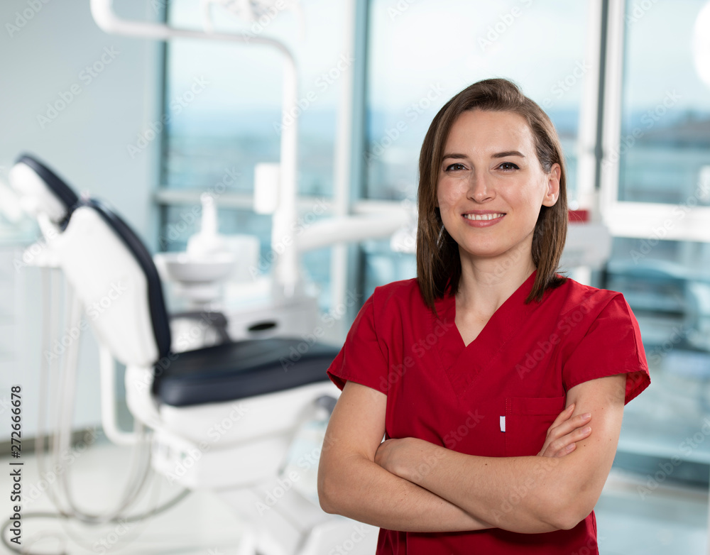 Fototapeta premium Portrait of female dentist standing in her office