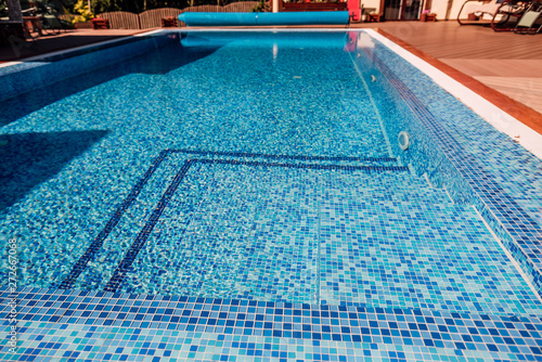 Hotel swimming pool with sunny reflections