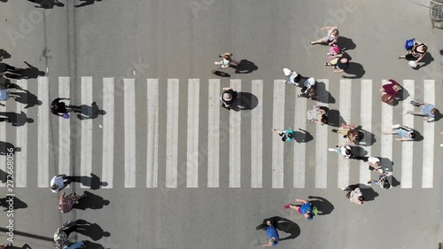 Aerial. People crowd on pedestrian crosswalk. Top view. 