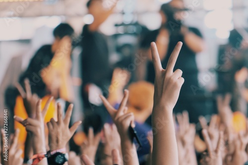 People held two fingers at the concert.