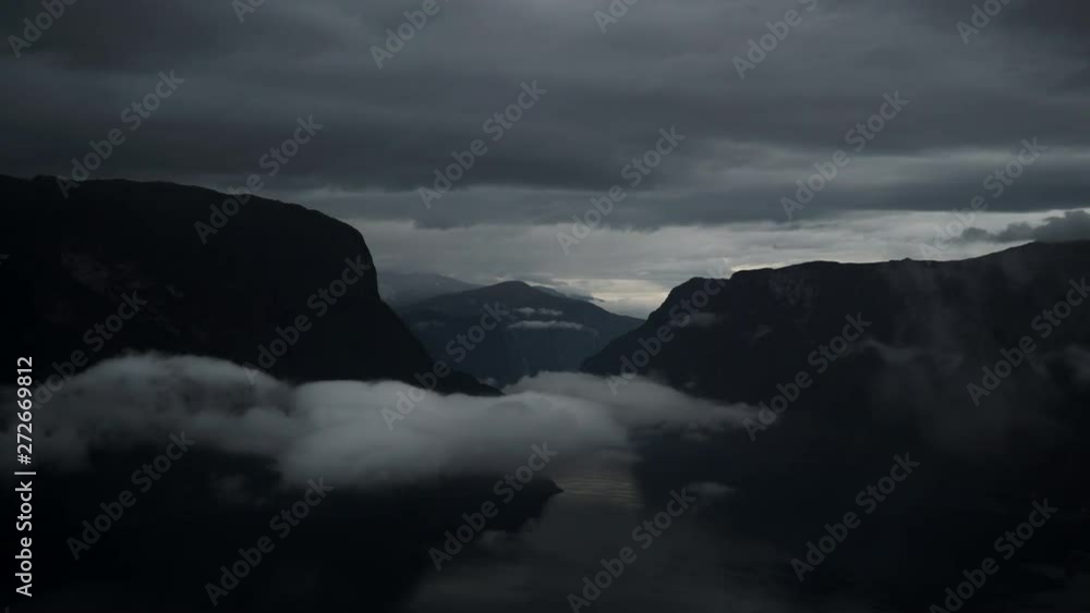 Clouds moving over sea fjord Aurlandsfjord. Norwegian mountains landscape. View from Stegastein viewpoint. National tourist route Aurlandsfjellet. Time lapse Clouds moving over sea fjord Aurlandsfjord. Norwegian mountains landscape. View from Stegastein viewpoint. National tourist route Aurlandsfjellet. Time lapse