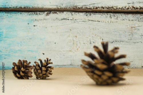 Three spruce cones lies on the craft background. The concept of winter and Christmas.