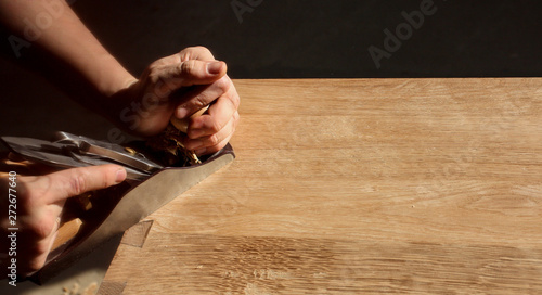 Cabinetmaker produces furniture using planer