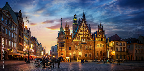 Wroclaw central market square with old houses, Town Hall and sunset, horse and carriage. Panoramic night view, long exposure.  Historical capital of Silesia, Wroclaw (Breslau) , Poland, Europe.
