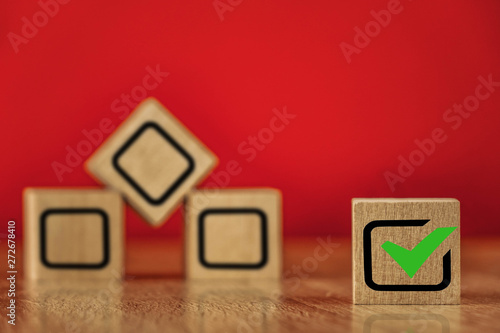 Wooden cubes with drawn marks on the red background © Влад Астанин
