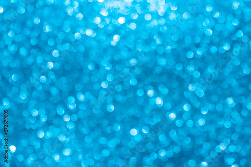 blue Sparkling Lights Festive background with texture. Abstract Christmas twinkled bright bokeh defocused and Falling stars. Winter Card or invitation