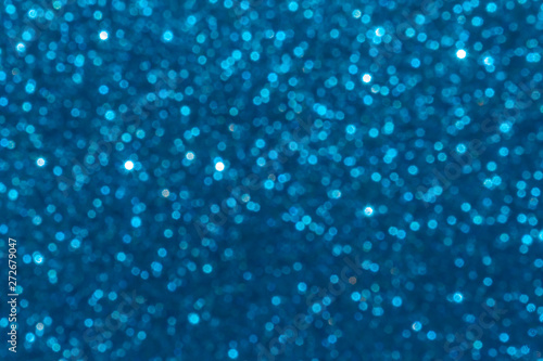 blue Sparkling Lights Festive background with texture. Abstract Christmas twinkled bright bokeh defocused and Falling stars. Winter Card or invitation