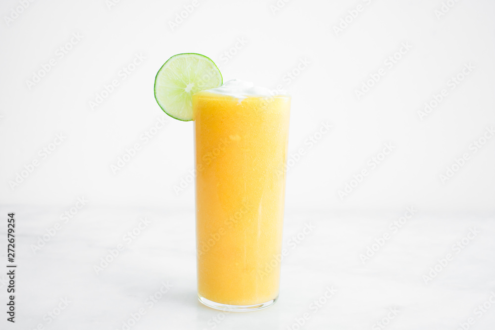 Mango Coconut Cocktail with a Lime Garnish Mango Coconut Cocktail with a Lime Garnish