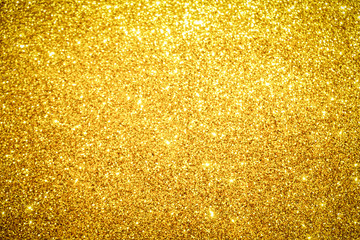 gold Sparkling Lights Festive background with texture. Abstract Christmas twinkled bright bokeh defocused and Falling stars. Winter Card or invitation