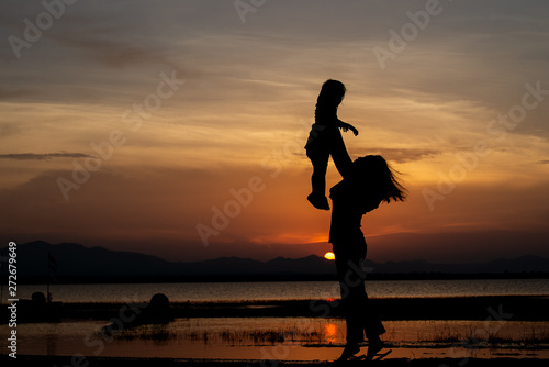 Silhouette of mother and daughter on sunset Thailand people Happy family concept