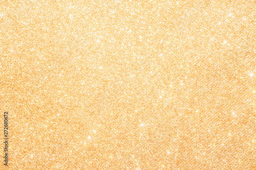 gold Sparkling Lights Festive background with texture. Abstract Christmas twinkled bright bokeh defocused and Falling stars. Winter Card or invitation