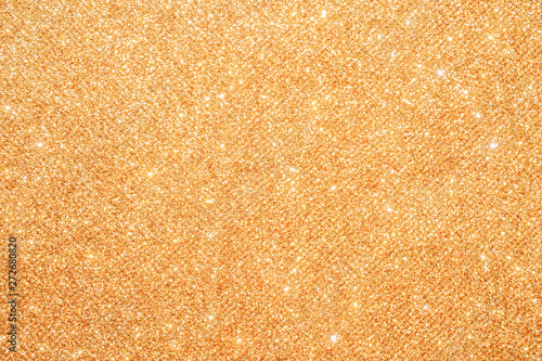 gold Sparkling Lights Festive background with texture. Abstract Christmas twinkled bright bokeh defocused and Falling stars. Winter Card or invitation