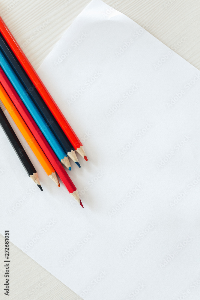 Colored pencils and paper Colored pencils and paper