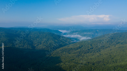 Aerial Landscape View of Caucasus mountain at sunny morning with fog.