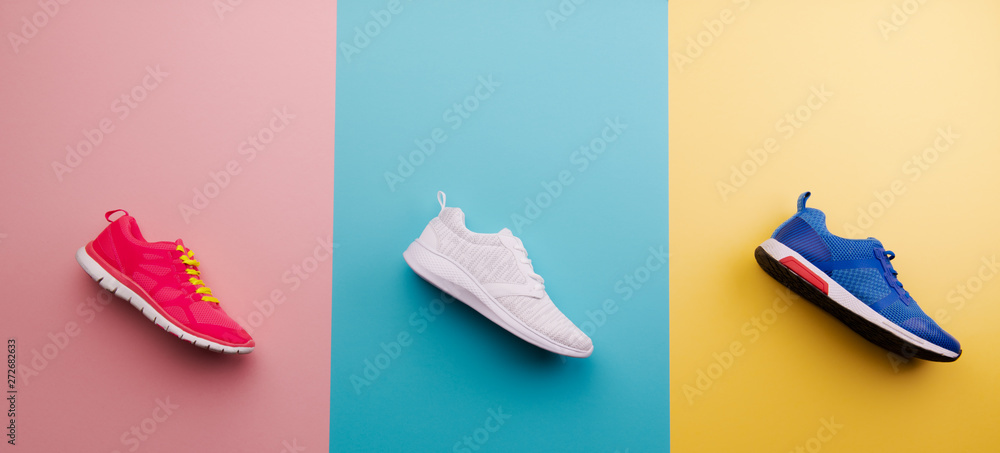 A studio shot of running shoes on bright color background. Flat lay. - obrazy, fototapety, plakaty 