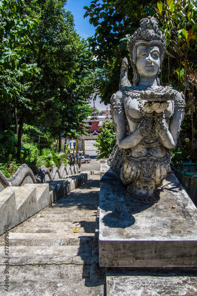 statue guarding stairs in thailand