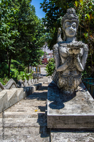 statue guarding stairs in thailand