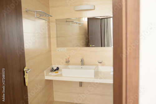 Spacious bathroom with toilet  bidet and shower in brown tones.