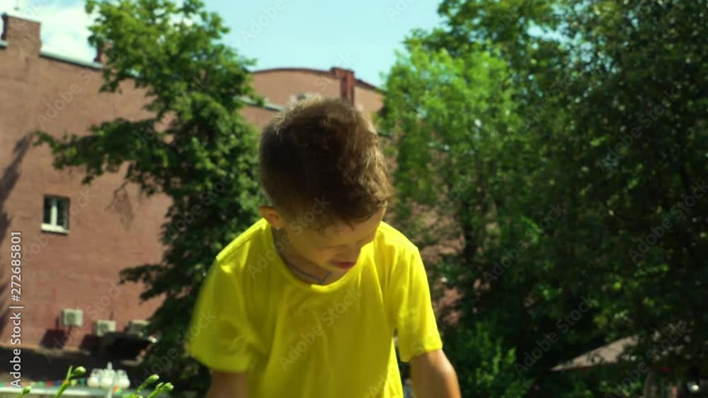 A six year old child is dancing. On a sunny summer day, the child makes faces at the camera. Two girls run by. A six year old child is dancing. On a sunny summer day, the child makes faces at the camera. Two girls run by.