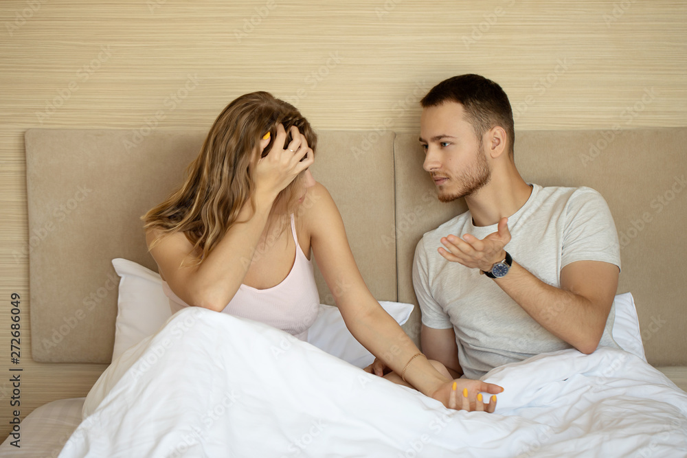Young Couple talking in bedroom. Young Couple talking in bedroom.