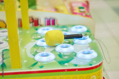 Фотография Side view of Whack a Mole with hammer for playing in game arcade