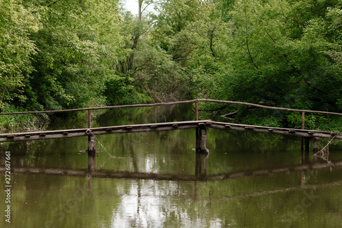 Old wooden bridge, wooden bridge across a small river, bridge with nature.