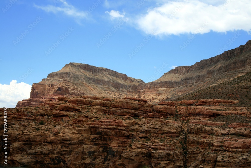 USA.  Red mountains Utah. View from the highway from car. Spring, fine weather. Grass on the rocks. Horizontal geological structure (line)