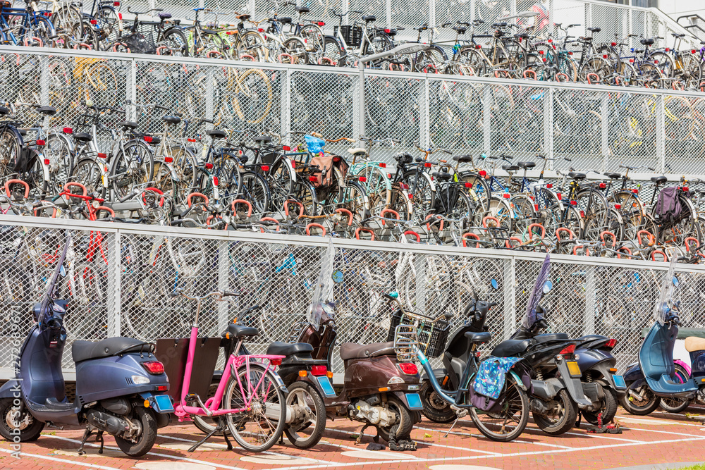Multi level outdoor bicycle and scooter parking near a trainstation in Alkmaar Netherlands