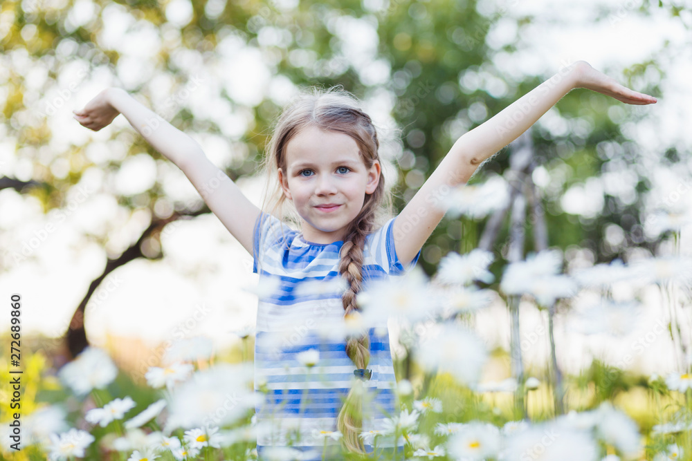 Little girl in a field among chamomile. Little girl in a field among chamomile.