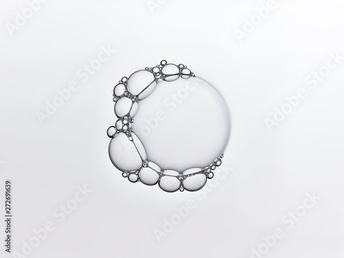 Clear bubble circle surrounded by smaller bubbles photo