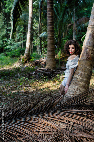 Young asian woman in the tropical forest.