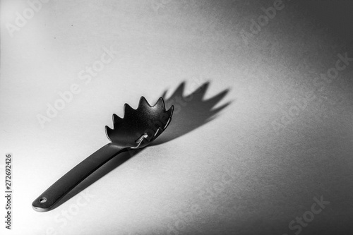 Everyday objects, black spoon for spaghetti and noodles photo