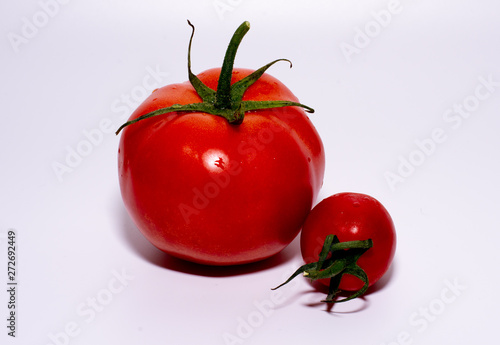 two tomatoes isolated on white background