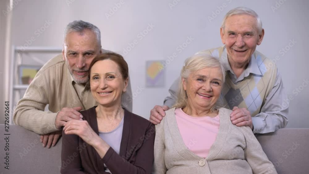 Senior couples hugging and smiling at camera, family portrait, togetherness